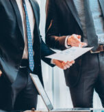Corporate meeting. Cropped shot of business partners working with graphs, reviewing statistics.